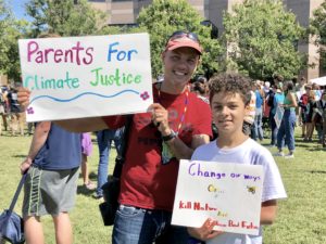 Parent with son attend a rally.