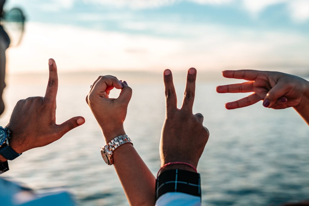 The word "love" spelled out with hands