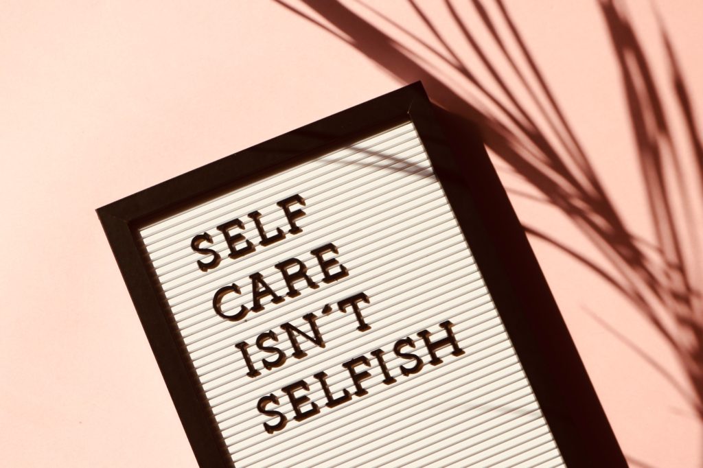 Board with Self Care Isn't Selfish written on it.